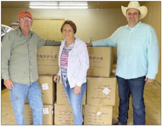 Harlan and Joyce Kobza (left) and Fayette County Emergency Management Coordinator Craig Moreau pose with the boxes of masks that were gifted to Fayette County by the Kobza’s son, Carman.