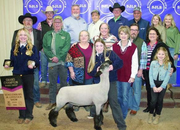 GRAND CHAMPION MARKET SHEEP – Exhibitor: Keaton Walker (front). Sales price: $6,900. Sticker Photo By Darrell Vyvjala