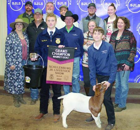 GRAND CHAMPION MARKET GOAT – Exhibitor: Koi Prihoda (front, right). Sales price: $6,000. Sticker Photo By Darrell Vyvjala