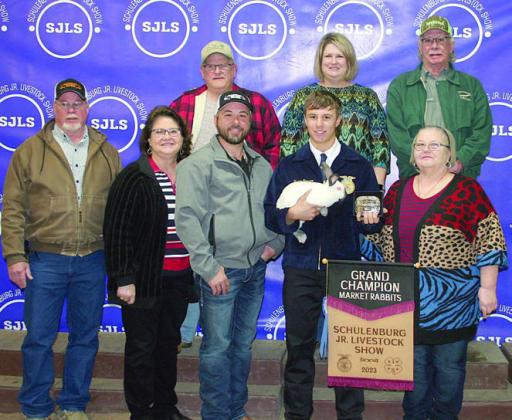 GRAND CHAMPION MARKET RABBITS – Exhibitor: Bryce Stoever (front, second from right). Sales price: $4,700. Sticker Photo By Darrell Vyvjala