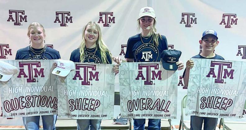 Awards – Holding the award banners are (from left) Haley Schramek, Keeley Warnken, Madyson Holub and Dylan Zweschper.