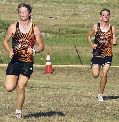 LJ Schindler (left) and Jamison Bennett head to the finish line. Sticker Photo By Darrell Vyvjala