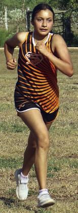 Ana Maria Granados finishes off her two laps. Sticker Photo By Darrell Vyvjala