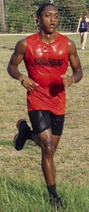 DeMarion Glass completes his seventh-place for the JV Horns after getting doused with water by some cross country teammates. Sticker Photo By Darrell Vyvjala