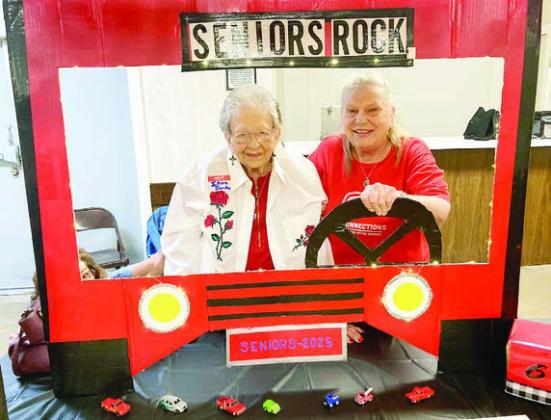 At the summer picnic, having fun in the photo booth made by Martha Beckmann are (from left) Irene Janda and her first cousin Annette Jasek.