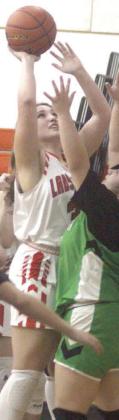Grace Schramek scores over a Lady Bobcat in the second half. Sticker Photo By Darrell Vyvjala