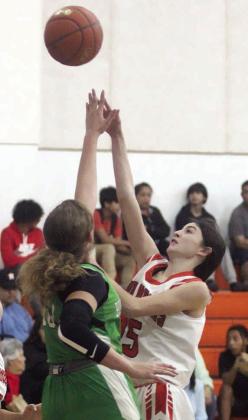 Ava Faith hits a shot in the lane against Bloomington in the first half. Sticker Photo By Darrell Vyvjala