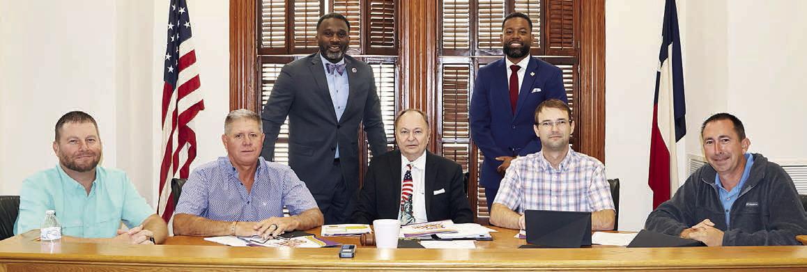 Commemorating the new collaboration between Prairie View A&amp;amp;M University Extension Office and Fayette County are: (front, from left) Precinct 4 Commissioner Drew Brossmann, Precinct 3 Commissioner Harvey Berckenhoff, County Judge Dan Mueller, Precinct 2 Commissioner Clint Sternadel, Precinct 1 Commissioner Jason McBroom; (back, from left) Extension Agent Ronnie McDonald, and Assistant Program Leader Natriez Peterson. Photo By Melanie Berger / Courtesy of Flatonia Argus