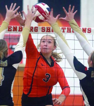 Reagan Dusek powers a kill of the hands of Giddings blockers in the third set. Sticker Photo By Darrell Vyvjala