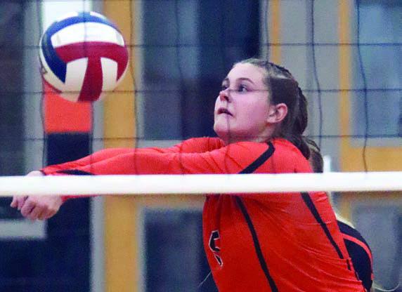 Haylee Vacek saves a deflected ball at the net in game two last Tuesday. Sticker Photo By Darrell Vyvjala