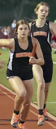 Haylee Vacek takes the baton from Michaela Kollmann for the 1600-meter relay team that finished third. Photo By Melanie Berger / Courtesy of Flatonia Argus