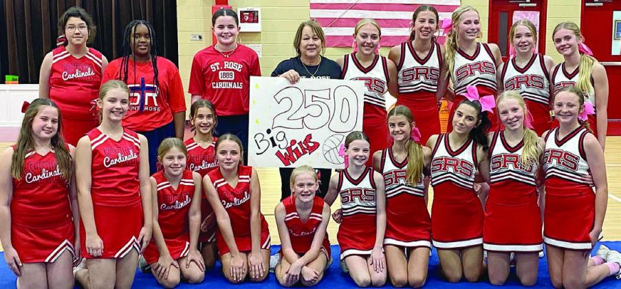 Congratulating coach Sandy Zaruba on reaching the milestone win total of 250 are: (front, from left) Annaston Kutac, Cate Hooper, Briley Stoever, Brielle Goedrich, Kinsley Zapalac, Brillen Hartensteiner, Rylee Wright, Clare Besetzny, Ellia Wotipka, Brynn Bubela, Caroline Bartek; (back, from left) Raven Demel, Jade Williams, CC Schmidt, coach Sandy Zaruba, Tenley Zbranek, Courtney Magliolo, Saybra Pinney, Reese Dusek, and Mallory Bonner.