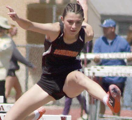 Ava Faith clears a hurdle in the 100-meter event on her way to a fifth-place finish. Sticker Photo By Darrell Vyvjala