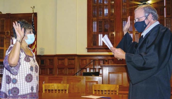 In a special ceremony held in the District Courtroom of the Fayette County Courthouse on Friday morning, Sept. 11, Sylvia Mendoza (left) was sworn in as the interim Fayette County Tax Assessor-Collector by Fayette County Judge Joe Weber (right). Photo By Melanie Berger / Courtesy of Flatonia Argus
