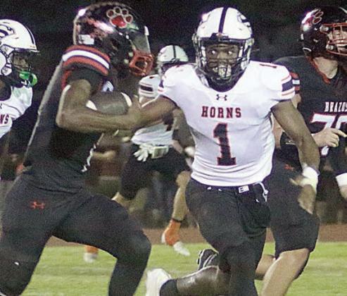 DaTerrion Houston chases down Jarvse Dickerson for a stop on fourth down in the second quarter. Sticker Photo By Brandt Vyvjala