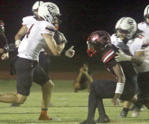 Jayse Janda takes a screen for 14 yards in the first quarter, using a block from Keigan Johnson (right). Sticker Photo By Brandt Vyvjala