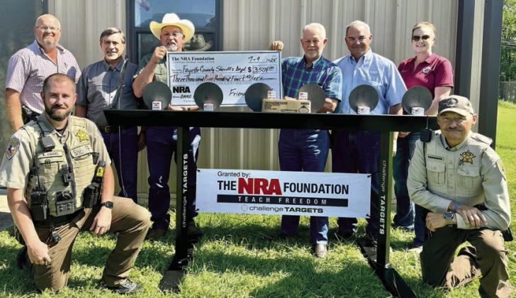 The Fayette County Sheriff 's Office was the recipient of a $3,504 grant from The NRA Foundation and Friends of NRA. Shown at the check presentation are (front row, from left) Deputy Seth Nagel and Sgt. Ron Naumann; (back row) Lt. David Beyer; John Salem, representing Friends of NRA; Sheriff Keith Korenek; Dennis Brower and Craig Schulz, representing Friends of NRA; and Sgt. Angela Lala.
