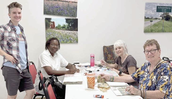 In her Artful Friday class, Jaime Janda (left) consults with some of the creative ladies.Working on their art journals are (continuing from left) Deborah Jones, Kim Penland and Berni Gillings. Each of their individual creations is a work of art.