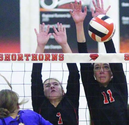 Meredith Magliolo (No. 11) sends back a Weimar spike in the third set with an assist from Landry Zapalac. Sticker Photo By Darrell Vyvjala