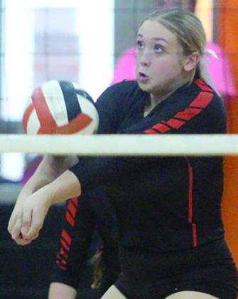 Reagan Dusek picks up a dig after a Ladycat tip in the fourth game on Friday. Sticker Photo By Darrell Vyvjala