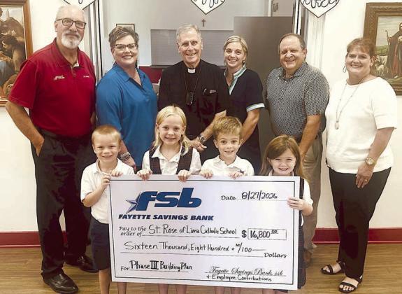 On hand as a $16,800 check was presented by Fayette Savings Bank to the St. Rose of Lima Catholic School Phase III Building Project were (front row, from left) St. Rose students Waylon Neskora, Paisley Guentert, Henry Neskora and Drew Schneider; (back row) Mike Olle and Cheryl Brossmann, FSB and personal donors; Fr. Jasper Liggio, St. Rose pastor; Taylor Jensen St. Rose School principal; and Rodney Kalich and Darlene Brothers, FSB and personal donors.