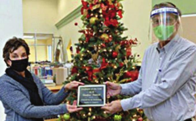 EMPLOYEE OF THE YEAR – Diana Mikesky (left), representing the Chamber of Commerce, presents the “Employee of the Year” award to Thadious Polasek.