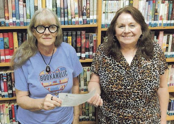 A $6,000 grant from the Tocker Foundation is displayed by Schulenburg Public Library librarians (from left) Cindy Lytle and Donna Holub.