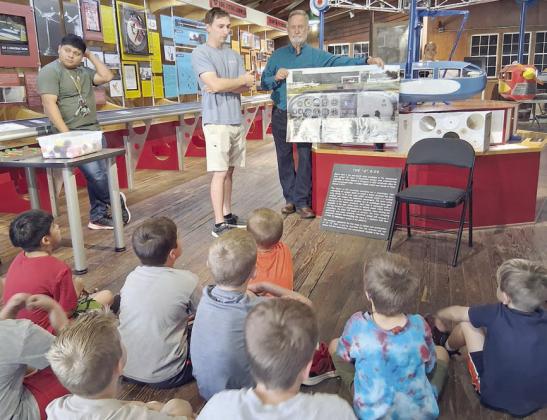 Professional pilots Garrett Olive and Jimmy Jacobs teach Stanzel co-pilots all about the aviation six-pack, six gauges that help a pilot prepare to take off and to maintain safety in flight.