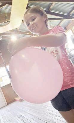 Preparing to launch her balloon rocket is Lilly Muras.