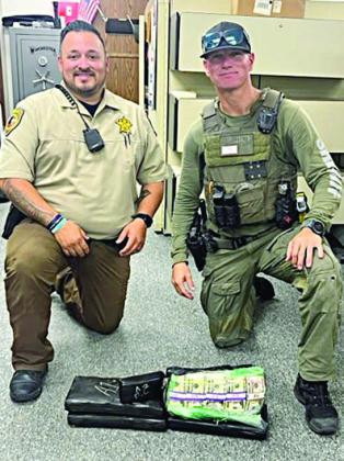 Deputy Herman Olvera (left) and Drug Interdiction Investigator David Smith (right) are pictured with the $191,000 in U.S. currency seized after a traffic stop on Interstate 10.