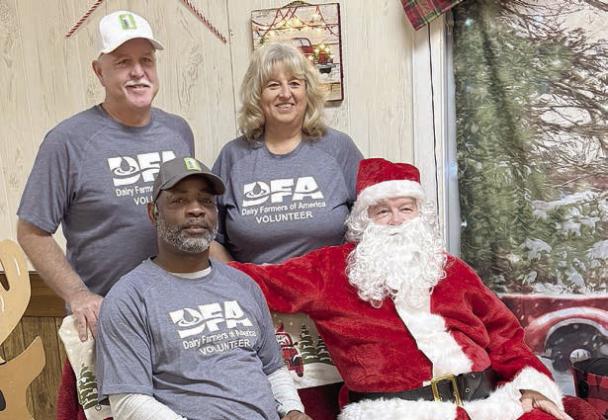 Volunteers from Dairy Farmers of America shown with Santa are (front) Leon Brooks, (back, from left) Johnny Osborn and Jackie Vornsand.