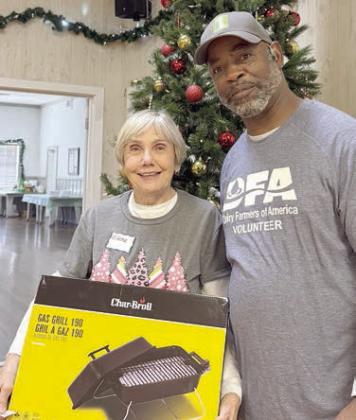 Lucky winner of this tabletop grill donated by Dairy Farmers of America and presented by Leon Brooks (right) was Elena Horndt (left).