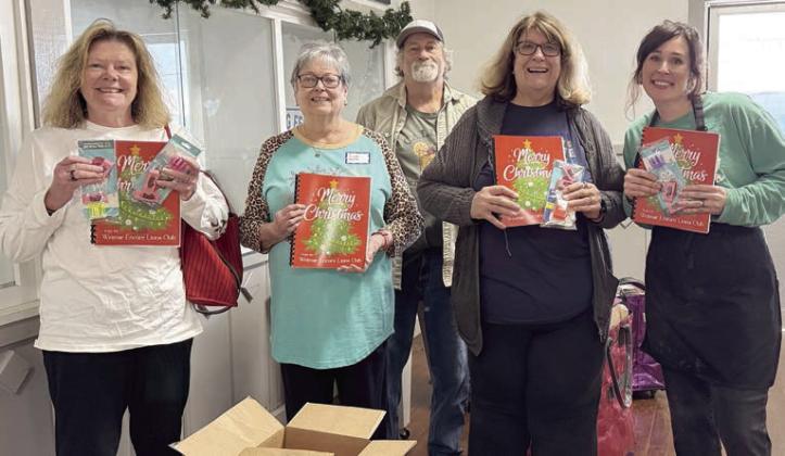 Weimar Encore Lions Club donated these fun activity books for Senior Connections members. The books came with coloring tools too! Shown are (from left) Nancy Parrish, Linda Heller, Tommy and Denise Koenig, along with Senior Connections executive director and head chef Amanda Kridel.