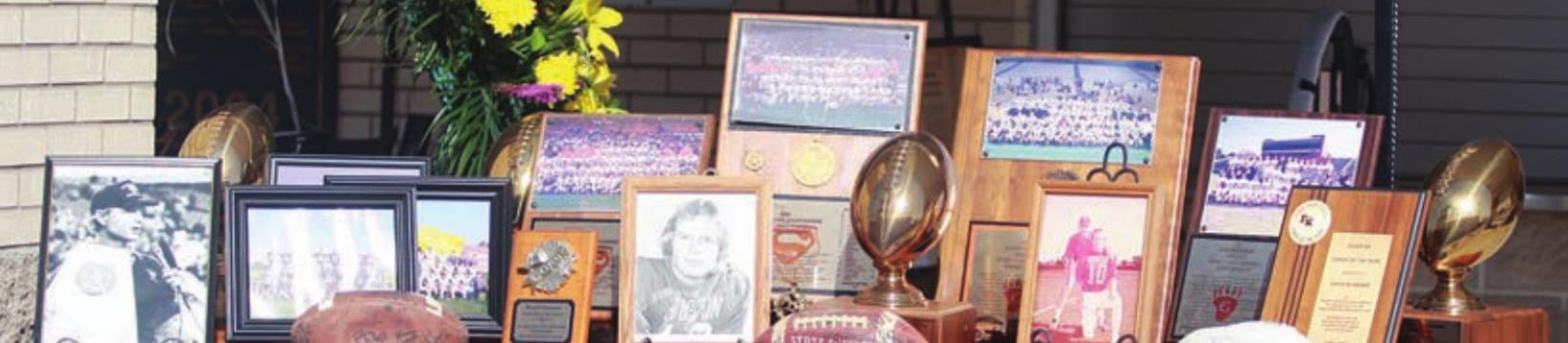 A display outside the gym included trophies, photos, and memorabilia from coach Husmann’s days at the University of Houston as well as his coaching career. Sticker Photo By Darrell Vyvjala