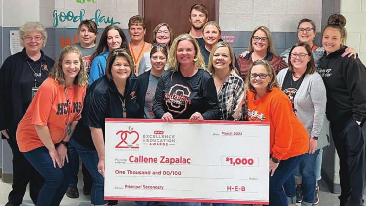 Junior High teachers and staff on hand to congratulate Principal Callene Zapalac (front, holding check) after notification came that she was a finalist for the H-E-B Excellence in Education award were: (middle, from left) Kayla Willey, Rhonda Walters, Michelle Beyer, Amy DeMarco, Kim Wellborn, Megan Zapalac; (back, from left) Jeraline Wick, Melissa Adcox, Jennifer Knigge, Donna Janda, Sharon Jochen, Wesley Kutac, Melissa Zapalac, Heather Pavlu, Amy Brenner, and Lindy Lantelme.