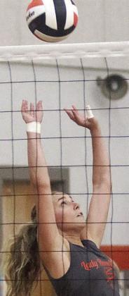 Junior Jenna Guentert back-sets to a teammate Friday morning as she makes the switch from libero this season. Sticker Photo By Darrell Vyvjala
