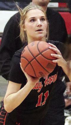 Alana Herzik lines up a three-pointer in the third quarter. Sticker Photo By Darrell Vyvjala