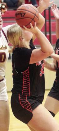 Ava Bubela comes down with an offensive rebound in the final period. Sticker Photo By Darrell Vyvjala
