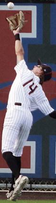 Left fielder Connor Lichnovsky runs down a deep drive in game one. Sticker Photo By Darrell Vyvjala