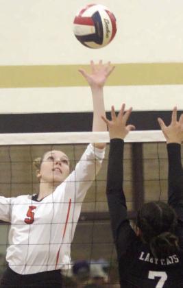 Brooke Redding goes to her left hand to tip down a ball for a kill in the third set. Sticker Photo By Darrell Vyvjala