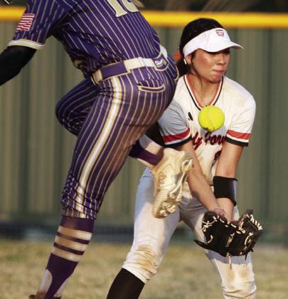 A Shiner baserunner avoids a grounder and second baseman Perla Martinez stays with a high hop to get an out at first base. Sticker Photo By Darrell Vyvjala