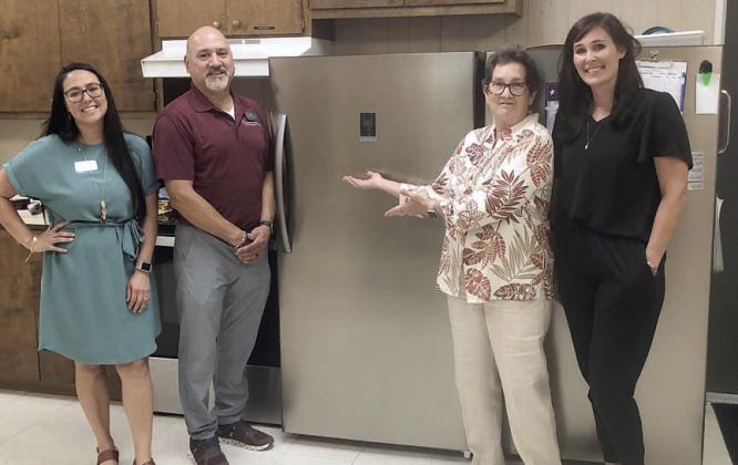 A new freezer was donated to Senior Connections by Wellsential nursing facility in Halletsville. Shown with the freezer are (from left) Erica Furnace and Anthony Villanueva, representing Wellsential; Stephanie Shroyer, Senior Connections program director; and Amanda Kridel, Senior Connections executive director.