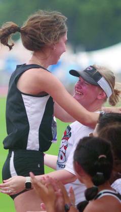 After clearing 5’5”, Meredith Magliolo shows her excitement on the high jump matt (left) and then by leaping into the arms of coach Carol Hargadine (right). Sticker Photos By Darrell Vyvjala