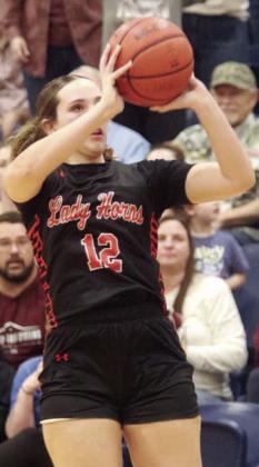 Grace Schramek gets the Lady Horns to within three points with a trey late in the game. Sticker Photo By Darrell Vyvjala