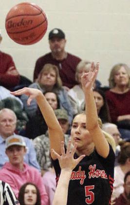 Jenna Guentert hits a three-pointer for the Lady Horns’ first basket. Sticker Photo By Darrell Vyvjala