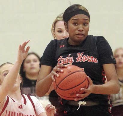 Jashiya Jackson comes down with a steal of an Iola pass in the final period. Sticker Photo By Darrell Vyvjala
