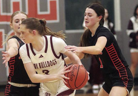 Ava Faith (right) and Mallory Bonner pressure a Lady Bulldog in the fourth quarter.