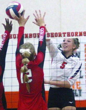 Brooke Redding sends an attack off a Burton block attempt in the second set. Sticker Photo By Darrell Vyvjala
