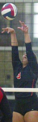 Kieryn Adams reaches up to get to a Burton attack in game two. Sticker Photo By Darrell Vyvjala