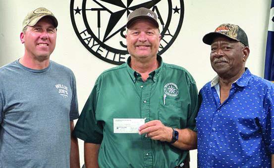 Schulenburg Economic Development Corporation President Paddy Magliolo (left) and Treasurer Ed Glass (right) present a $220,000 check to City Operations Manager Darryl Moeller. The funds will go toward paving at the Civic Center as well as on Matula, Kueper, and Avenue and B ($70,000) along with sewer line relocation and line replacement on College Street ($150,000.